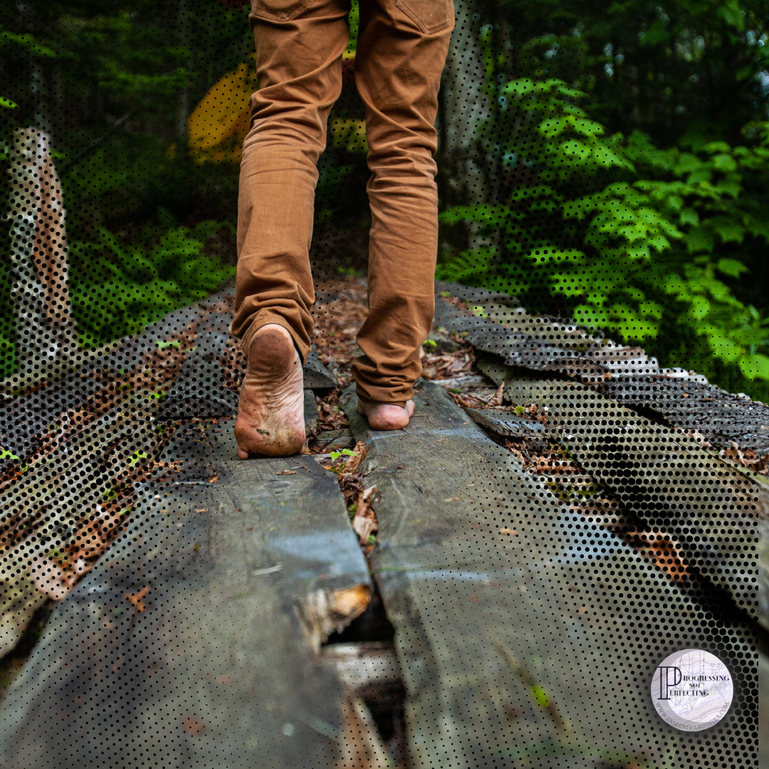 a person walking on a wooden bridge